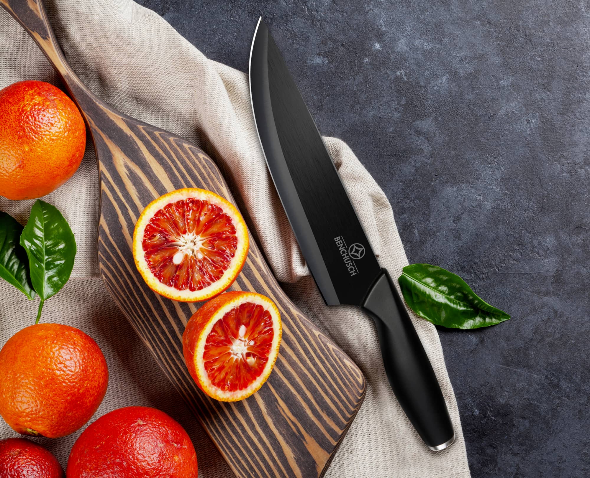 Benchusch Ceramic Knife 7 inch with cutting red orange and the chopping board on the dark background
