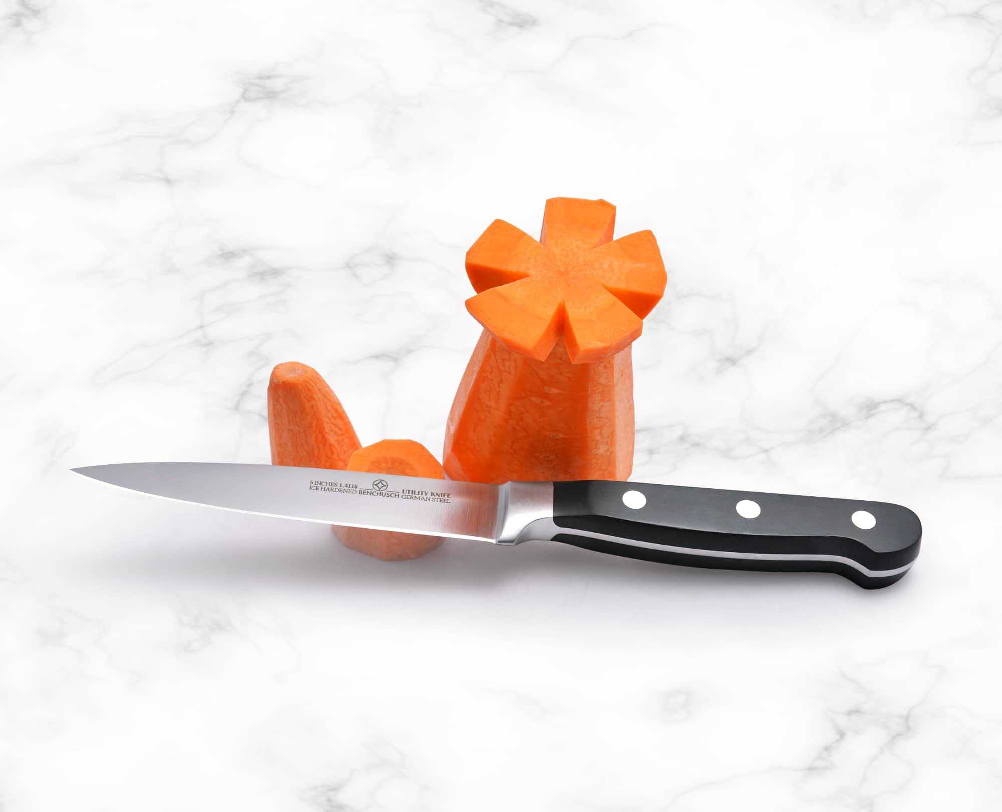Benchusch Classic 5-inch Utility Knife with cutted carrot on the marble background