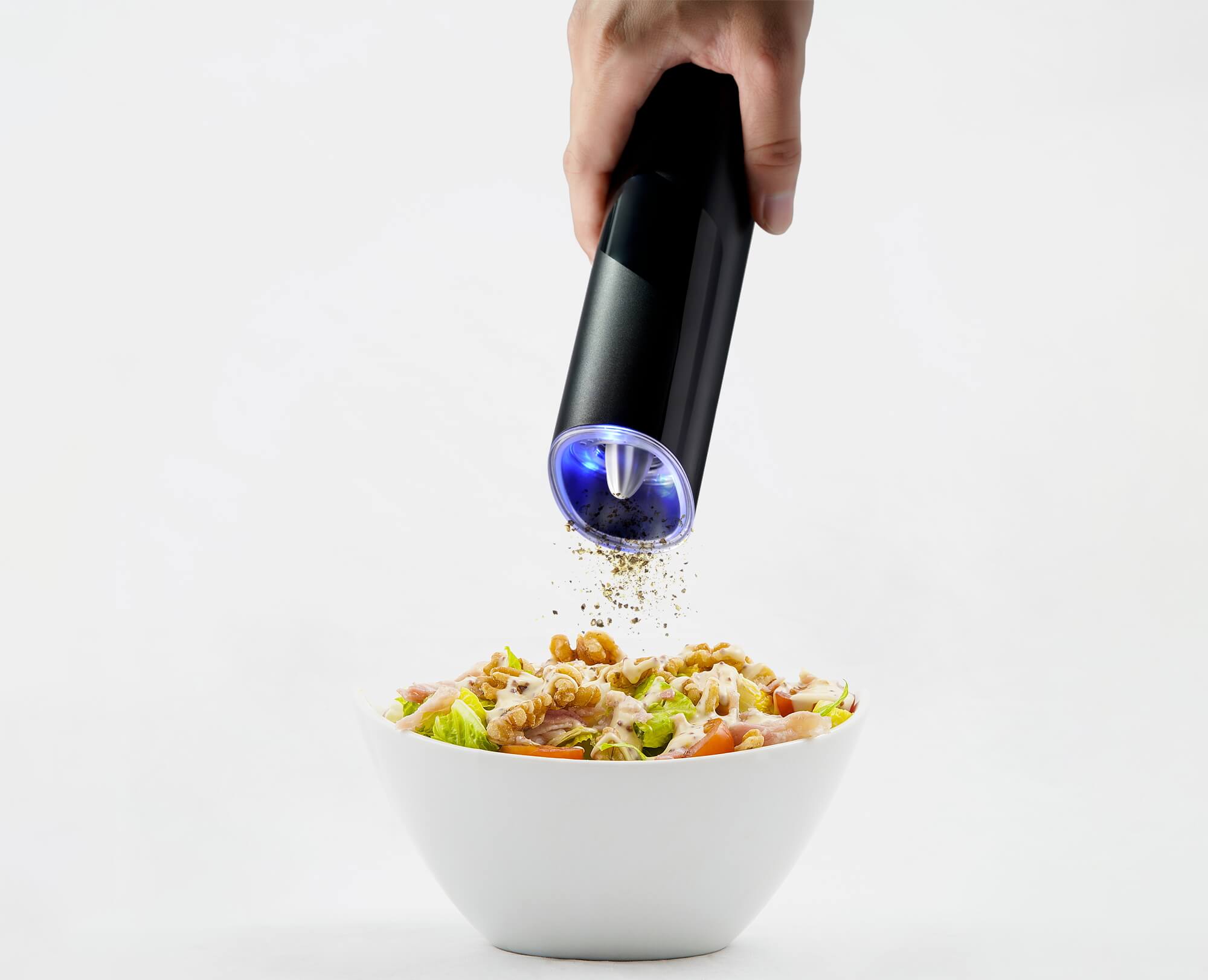 Grinding pepper to the delicious food with Benchusch Modern Electric Gravity Pepper Grinder on the white background
